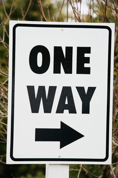 Close up of a one way sign.