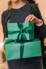 The girl holds in her hands a gift box