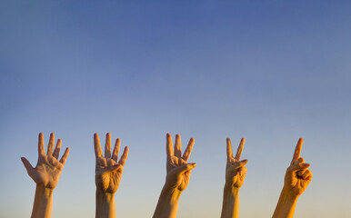 Hand countdown concept. Counting down on blue background. Gesturing number 5, 4, 3, 2, 1. Number...