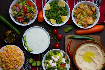 Assorted hummus, raita, Fattoush, Mutabal, Quinoa Salad, snack served in dish isolated on table top view of arabic food
