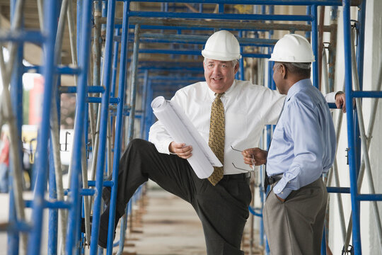Two engineers discussing at a construction site