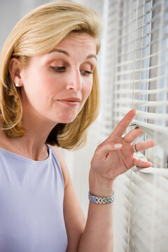 A business woman looking out from a window.