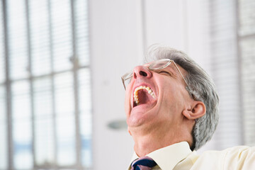 Business man laughing out loud.