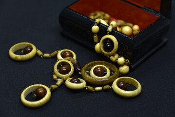 Wooden beads decoration on a black background. Wooden jewelry in a jewelry box.