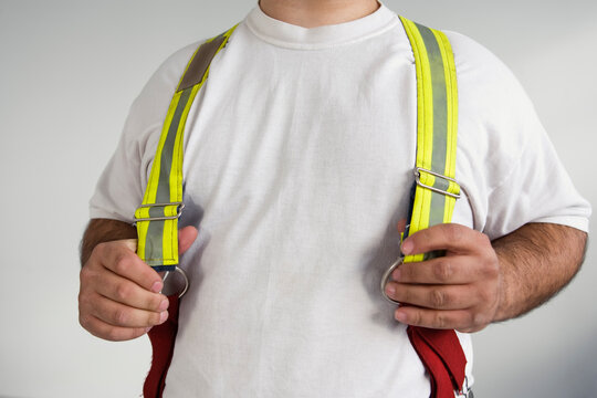 Midsection of a man wearing suspenders for a Fireman.