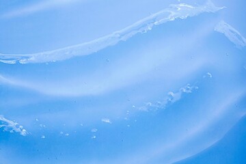 Cosmetic blue transparent texture. Serum or shower gel, shampoo background