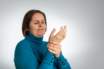 people, healthcare and problem concept - unhappy young woman suffering from pain in hand