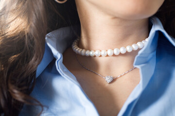 Close up of an mid adult woman wearing beads.