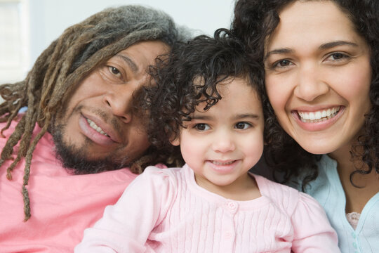 Portrait of a mid adult couple smiling with their daughter
