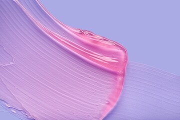 Liquid cosmetic gel or serum texture smudge pink on purple