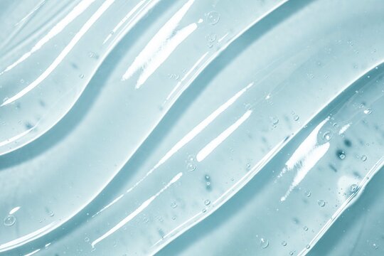 Cosmetic transparent blue texture. Serum or shower gel, shampoo background