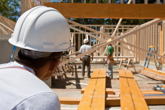Carpenters framing a house