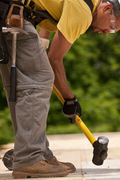Carpenter using a sledgehammer