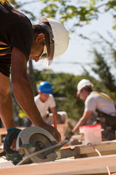 Carpenters using circular saw at a construction site