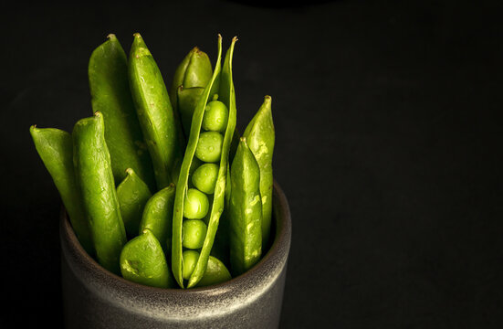 Pot with pea pods in studio