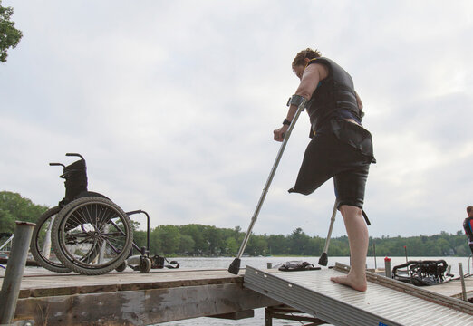 Woman with one leg waiting on the dock to go waterskiing