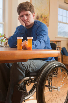 Woman with multiple sclerosis in a wheelchair choosing between subscription medicines