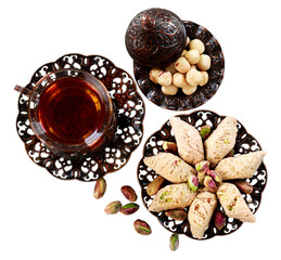 Bronze plate with arabian sweets and tea. Ramadan Kareem.