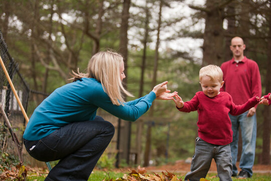 Woman signing the word 'Help' in American Sign Language while communicating with her son in a park