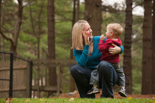 Woman signing the word 'Mommy' in American Sign Language while communicating with her son