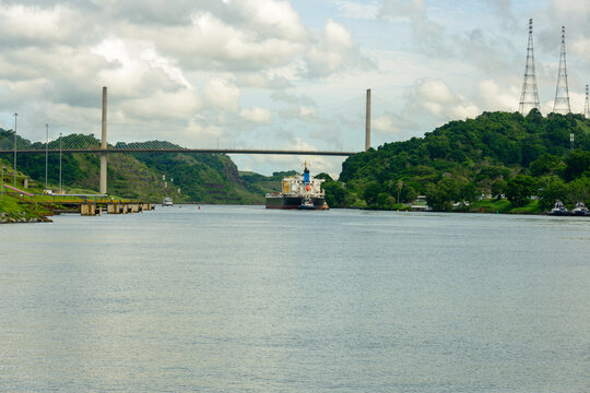 Freighter and tug approaching Centennial bridge near Pedro Miguel locks on the Panama canal.