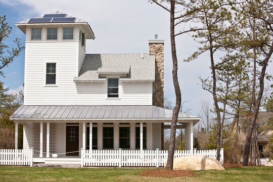 Green Technology Home with wrap-around porch, light reflective roof and solar electric power panels
