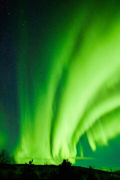 green northern lights in finland for textures, backgrounds for sustainable energy, darkness and lapland tourist magic for marketing