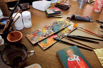 Many paint brushes and tools of the painter. Artist's desktop. Workflow of the artist in the studio. Brushes and paints on art workplace.