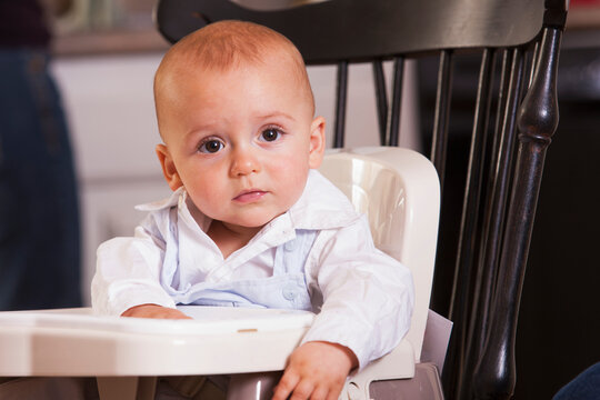 Baby boy sitting in a booster seat