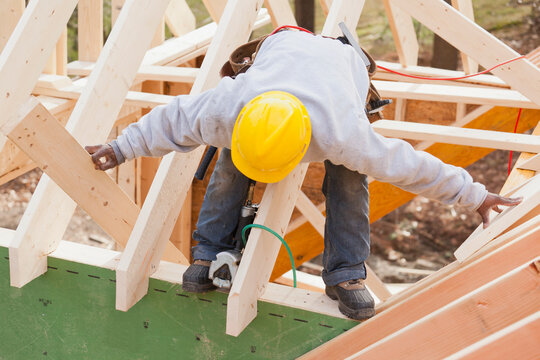 Carpenter lifting rafter for dormer
