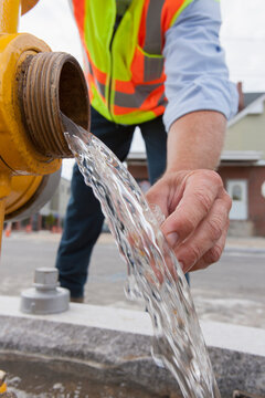 Engineer taking a water sample from a street hydrant