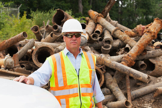 Engineer standing with old water pipes in the background