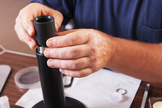 Engineer installing new membranes in an O2 electrochemical sensor probe in a laboratory