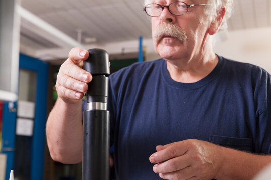 Engineer installing new membranes in an O2 electrochemical sensor probe in a laboratory