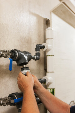 Engineer putting a rebuilt O2 electrochemical sensor probe into service on piping in water treatment plant
