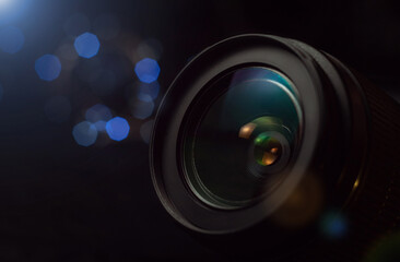 Camera lens close-up, lights out of focus on the background