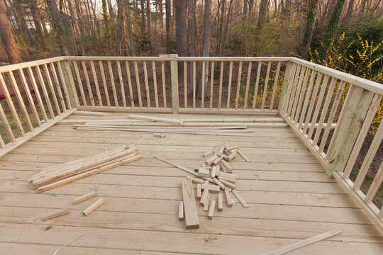 New deck under construction on home with railing in place