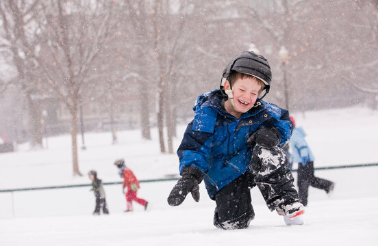 Boy getting up from a fall on skating rink