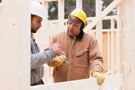 Construction foreman reviewing home under construction