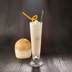 Thai Coconut Milkshake with straw served in glass isolated on table side view healthy morning drink