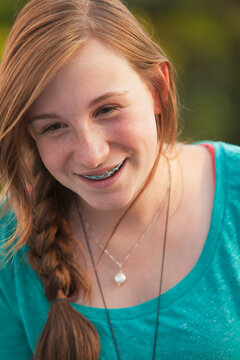 Close-up of a teenage girl smiling with braces on her teeth