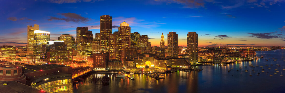 City skyline lit up at dusk with financial district and waterfront, Boston, Massachusetts, USA