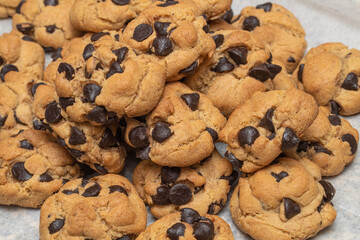Pile of chocolate chip cookies with extra chips
