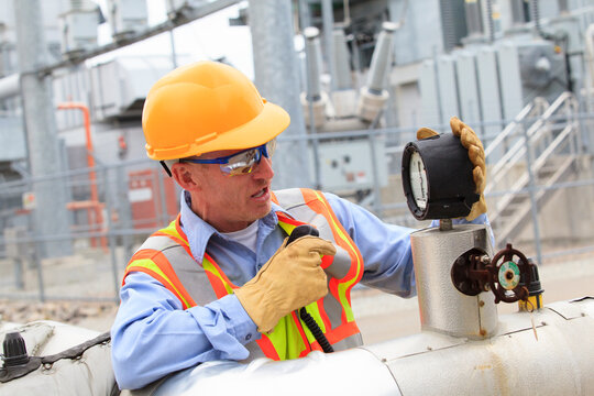 Electrical engineer examining pressure sensor at an electric power plant