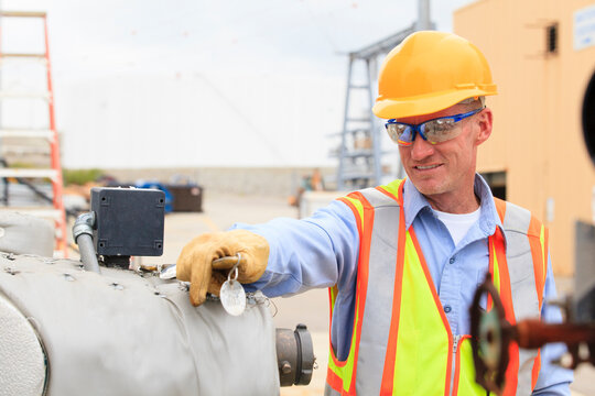 Electrical engineer examining pressure sensor at an electric power plant
