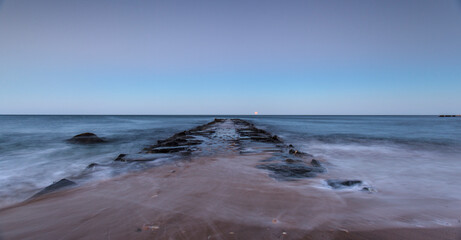 Moonrise over abandoned pier