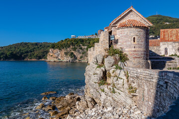 Scenic view of the wall of historical medieval citadel of Budva, Adriatic Mediterranean Sea, Montenegro, Balkan Peninsula, Europe. Old city fortress along the coast. Landmark along Budvanian Riviera