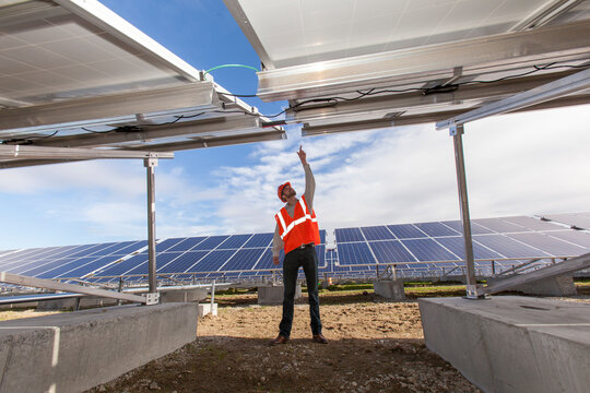 Solar photovoltaic installer examining racking for a PV array