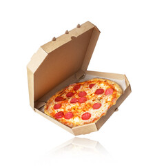 Freshly baked pizza with meat in a cardboard box on a white background
