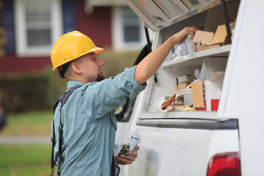 Lineman pulling supplies out of his truck for installation